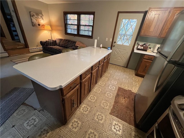 kitchen with a baseboard heating unit and a breakfast bar