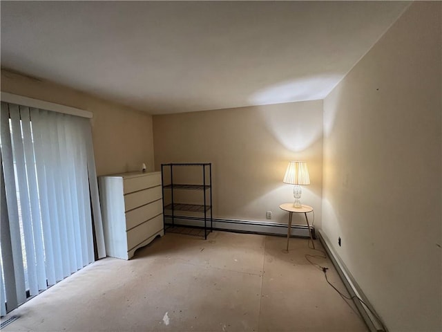 unfurnished bedroom with a baseboard heating unit