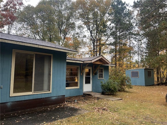 rear view of property featuring a lawn