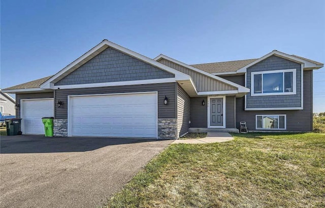 view of front facade with a garage and a front lawn