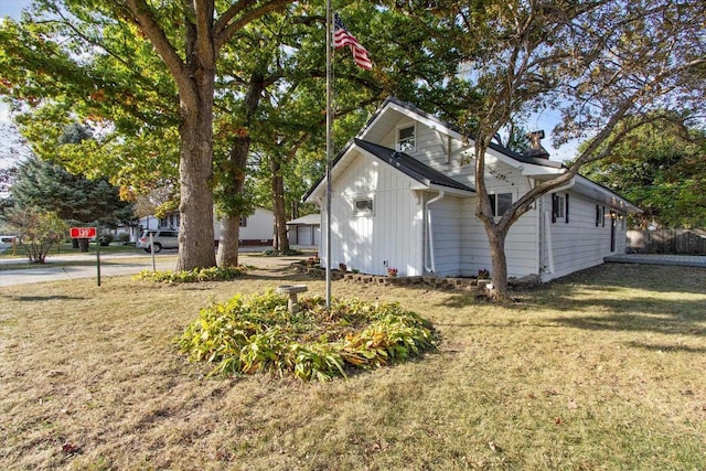 view of side of home with a lawn