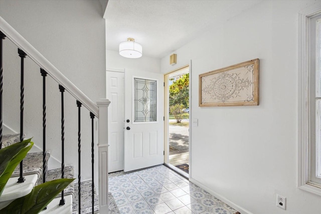 foyer featuring light tile patterned floors