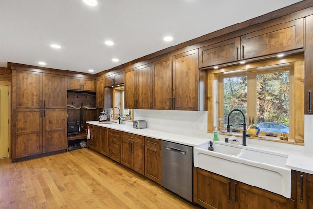 kitchen featuring light hardwood / wood-style flooring, sink, and stainless steel dishwasher