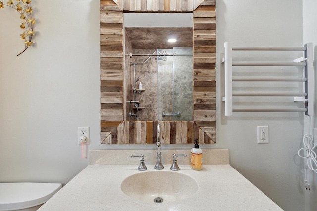 bathroom with vanity, toilet, and walk in shower