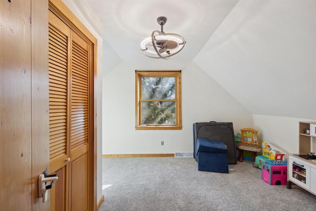 recreation room featuring carpet floors and vaulted ceiling