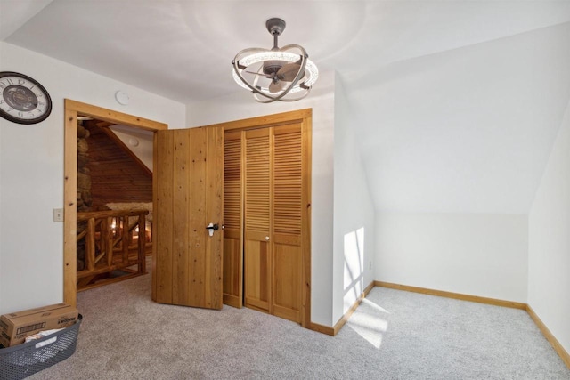 interior space featuring vaulted ceiling and carpet floors