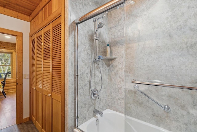 bathroom featuring combined bath / shower with glass door, hardwood / wood-style flooring, and wooden ceiling