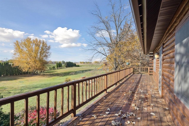 wooden deck with a lawn and a rural view