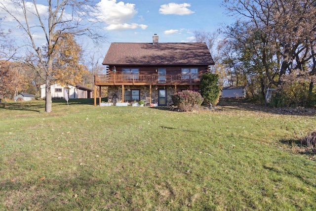 rear view of house featuring a deck and a yard