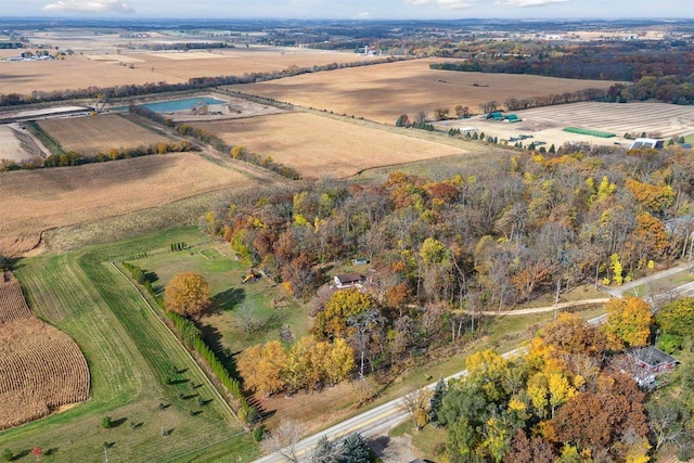 birds eye view of property with a rural view