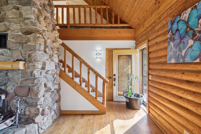 interior space with rustic walls, wood-type flooring, high vaulted ceiling, and wooden ceiling