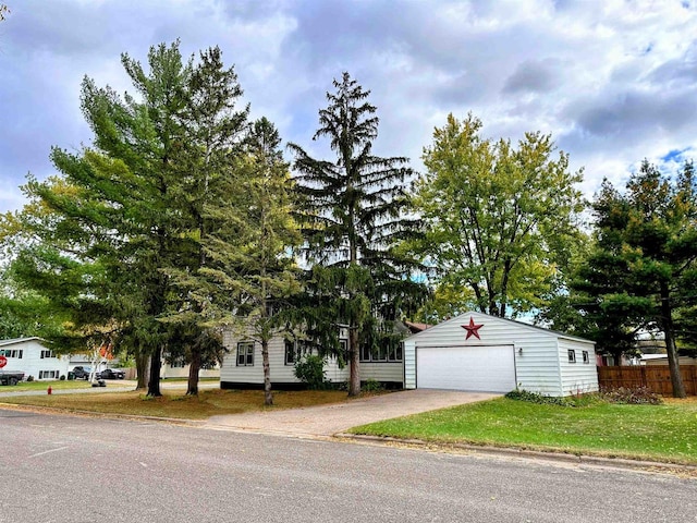 obstructed view of property with a garage and an outdoor structure