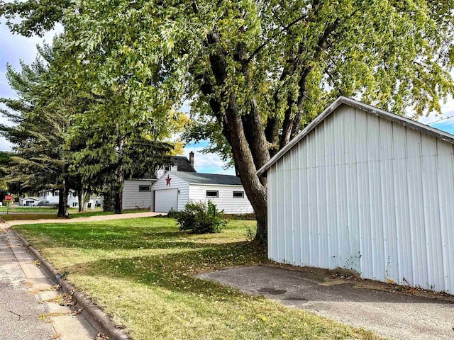 view of home's exterior featuring an outbuilding and a yard