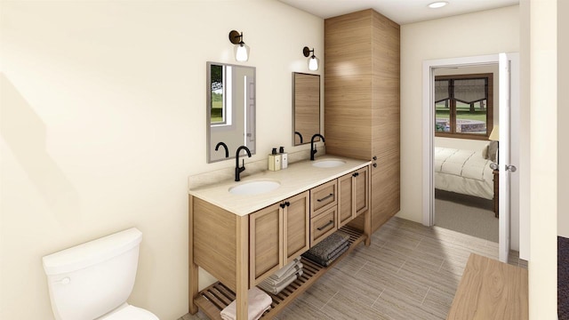 bathroom with vanity, a wealth of natural light, and toilet