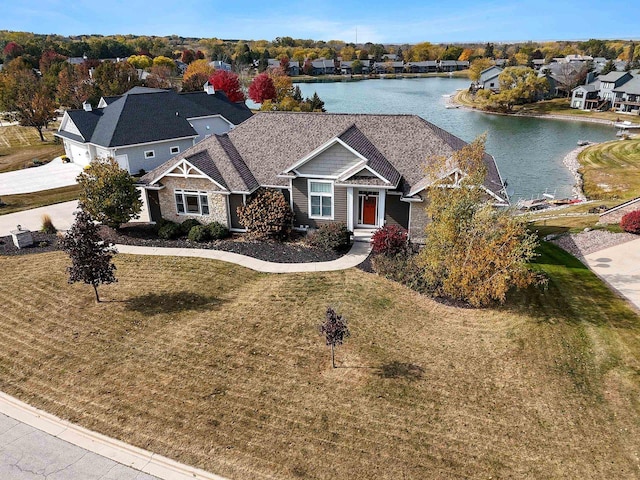 view of front of home featuring a front yard and a water view