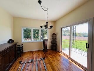 interior space with plenty of natural light, light hardwood / wood-style floors, and an inviting chandelier