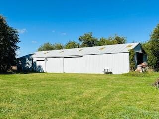 view of outdoor structure featuring a yard