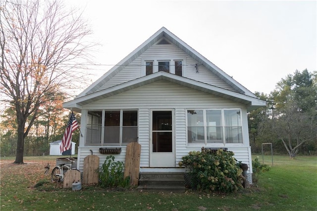 bungalow with a sunroom and a front lawn