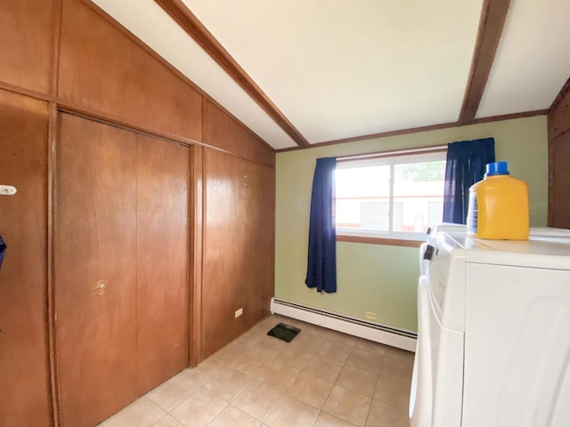 laundry room featuring washing machine and dryer, baseboard heating, and wooden walls