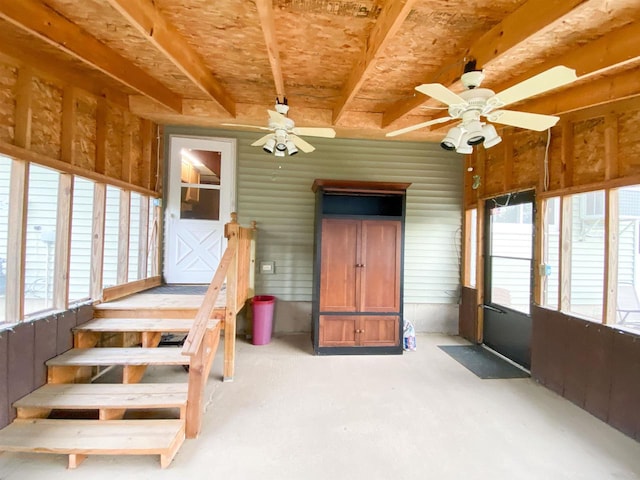 unfurnished sunroom featuring a wealth of natural light and ceiling fan