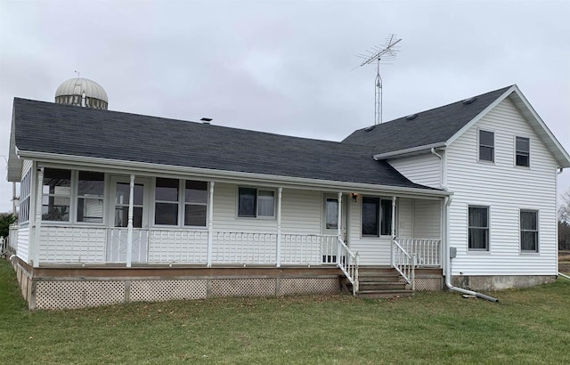 N8709 5th Ave, Camp Douglas, WI 54618 - rear view of property with covered porch, a lawn, and roof with shingles