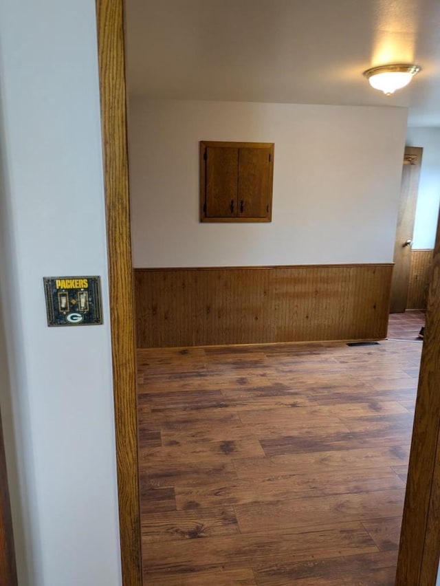 N8709 5th Ave, Camp Douglas, WI 54618 - spare room featuring wainscoting, wood finished floors, and wood walls