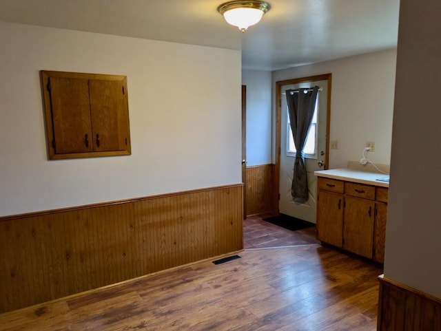 N8709 5th Ave, Camp Douglas, WI 54618 - empty room featuring wainscoting, dark wood-type flooring, and wooden walls