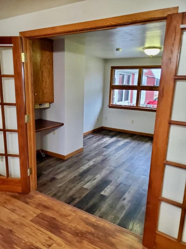 N8709 5th Ave, Camp Douglas, WI 54618 - unfurnished room with dark wood-type flooring and baseboards