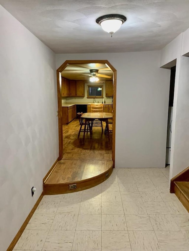 N8709 5th Ave, Camp Douglas, WI 54618 - corridor featuring arched walkways, light floors, and baseboards