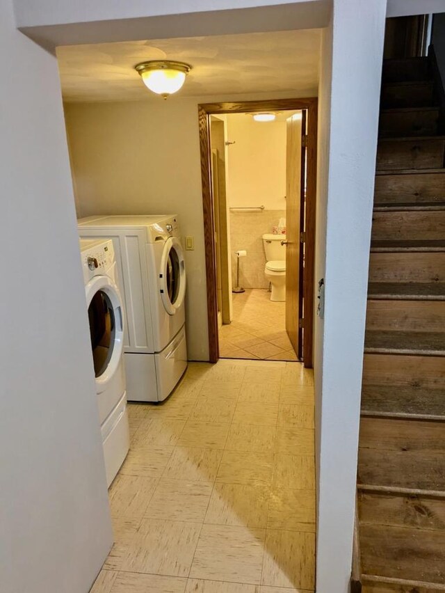 N8709 5th Ave, Camp Douglas, WI 54618 - laundry room featuring washing machine and dryer and light floors
