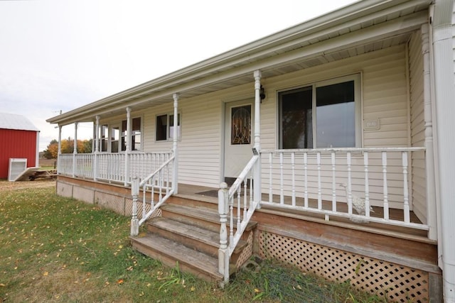 N8709 5th Ave, Camp Douglas, WI 54618 - doorway to property featuring covered porch and a yard