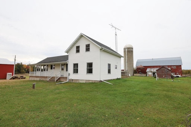 N8709 5th Ave, Camp Douglas, WI 54618 - rear view of house featuring covered porch and a yard