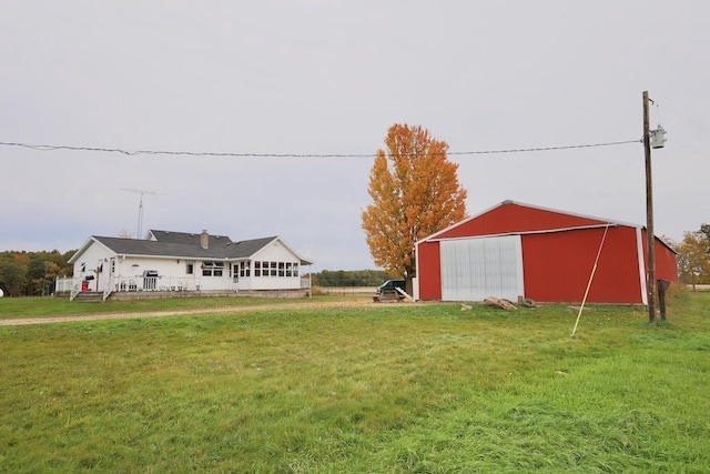 N8709 5th Ave, Camp Douglas, WI 54618 - view of green lawn featuring an outbuilding and a detached garage