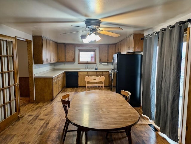 N8709 5th Ave, Camp Douglas, WI 54618 - kitchen featuring black appliances, a sink, light countertops, ceiling fan, and wood finished floors