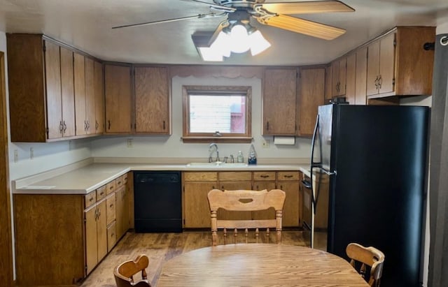N8709 5th Ave, Camp Douglas, WI 54618 - kitchen with dishwasher, freestanding refrigerator, a sink, a ceiling fan, and light countertops