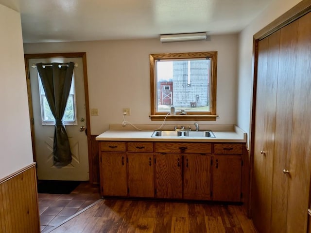 N8709 5th Ave, Camp Douglas, WI 54618 - kitchen with a sink, light countertops, brown cabinetry, and dark wood-style flooring