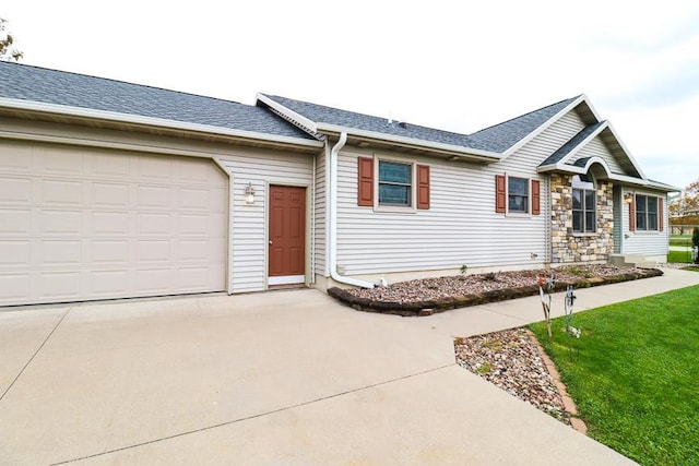 ranch-style house featuring a garage and a front yard