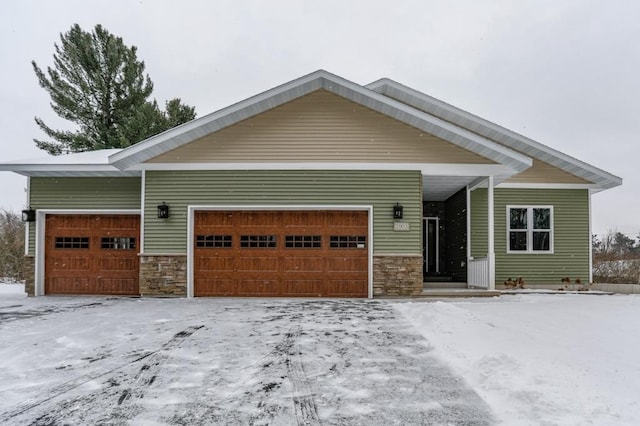 1003 E 10th St, Merrill, WI 54452 - view of front of property featuring stone siding and an attached garage