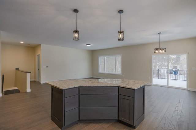 1003 E 10th St, Merrill, WI 54452 - kitchen with gray cabinetry, dark wood finished floors, open floor plan, decorative light fixtures, and recessed lighting