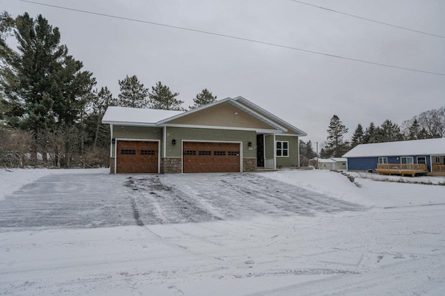 1003 E 10th St, Merrill, WI 54452 - view of front facade with an attached garage and stone siding