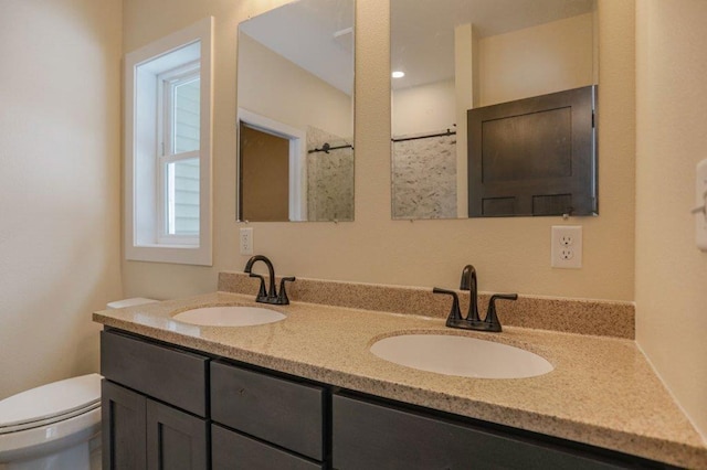 1003 E 10th St, Merrill, WI 54452 - full bathroom with toilet, double vanity, and a shower
