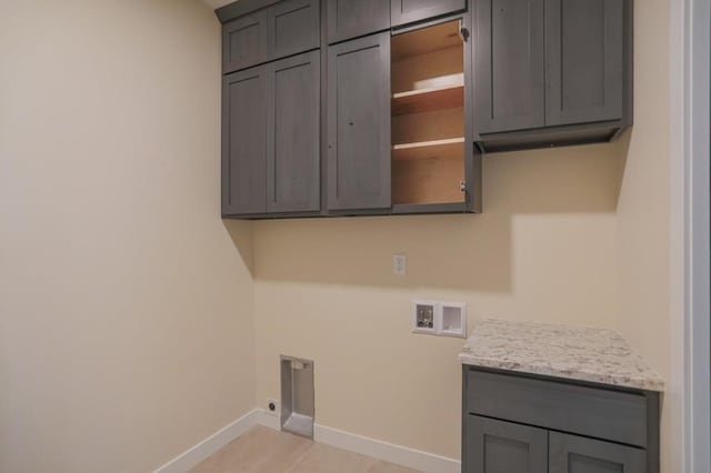 1003 E 10th St, Merrill, WI 54452 - laundry area featuring cabinet space, washer hookup, baseboards, and electric dryer hookup