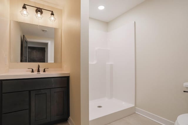 1003 E 10th St, Merrill, WI 54452 - full bathroom featuring baseboards, a shower, vanity, and toilet