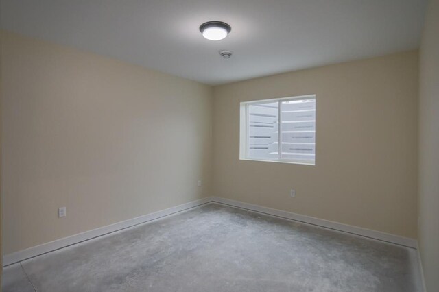 1003 E 10th St, Merrill, WI 54452 - spare room with unfinished concrete floors, baseboards, and a smoke detector