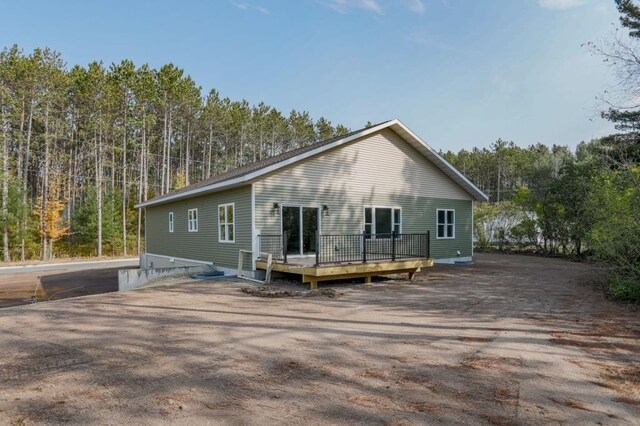 1003 E 10th St, Merrill, WI 54452 - view of front facade with stone siding, an attached garage, and dirt driveway