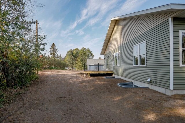 1003 E 10th St, Merrill, WI 54452 - rear view of property with a wooden deck and a view of trees