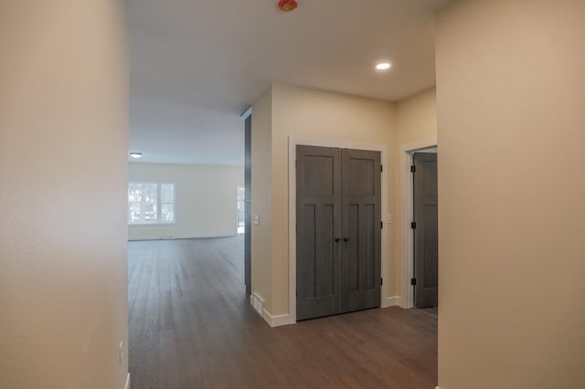 1003 E 10th St, Merrill, WI 54452 - hall featuring dark wood-style flooring, baseboards, and recessed lighting