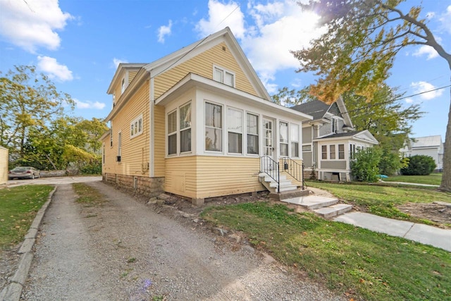 bungalow-style house featuring a front yard