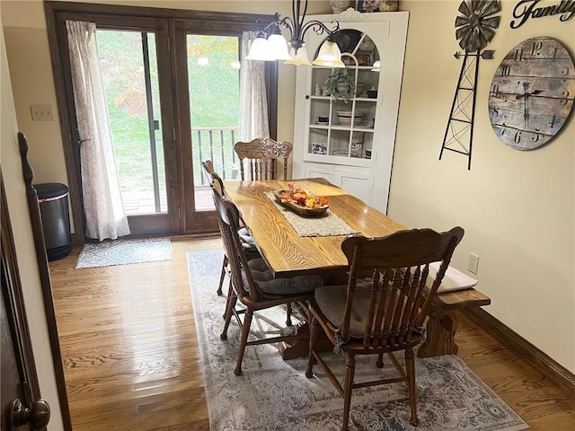 dining area featuring an inviting chandelier and hardwood / wood-style floors