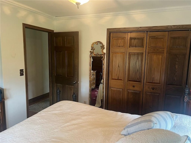 bedroom with a closet and crown molding